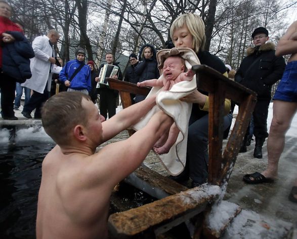 Russian parents Aleksander and Anna prepare to bathe their 2-month-old Viktor in icy water in St. Petersburg, where the air temperature was 27 degrees. Viktor obviously prefers hot baths. Photo: Dmitry Lovetsky, Associated Press